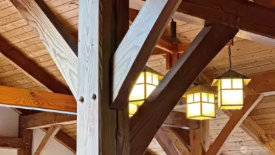 Timber framing is a majestic type of construction that utilizes exacting variations of mortise-and-tenon joinery and massive timbers to form the framework. The joints are secured with wooden pegs — no metal fasteners are used. The exposed fir timbers blend function and beauty creating stunning and unforgettable visual effects.