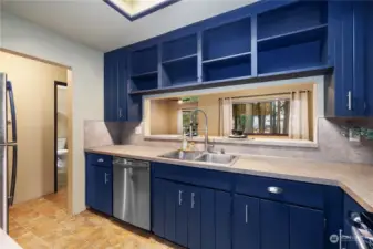 Kitchen opens to the living/dinning room with countertop bar seating for additional dining space.