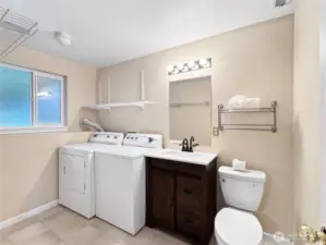 Laundry room with half bath and clothes hanging space makes laundry a breeze.