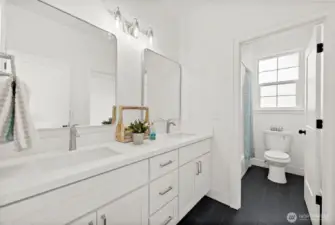 Private water closet with tub makes it easy and convenient to share this bathroom.