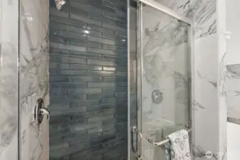 Beautiful tile work lines the double headed shower.