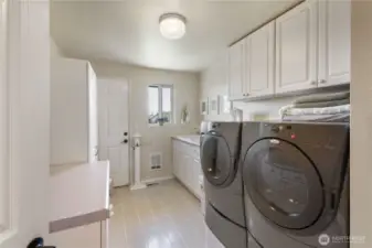 The large laundry has access to the back yard (hint-perfect for that hot tub you were thinking about). There is a large laundry sink and lots of storage.  The washer and dryer are included in the sale of this lovely home.
