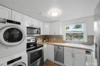 Kitchen with convenient washer and dryer.