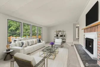 Living room w/ large windows & vaulted ceilings. Virtually staged.