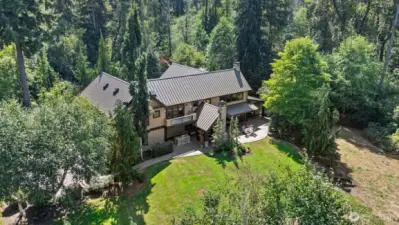 Private gated entry welcomes you to a secluded estate, where winding drive and mature trees create a natural buffer from the outside world. Surrounded by lush landscaping and native greenery, this tranquil retreat offers exceptional privacy.