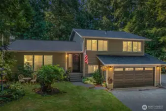 Nestled on a private lot framed by evergreens, this welcoming tri-level home offers warmth and character from the moment you arrive. A charming entry, accented by thoughtfully landscaped garden beds and a classic covered front porch, sets the stage for what awaits inside.