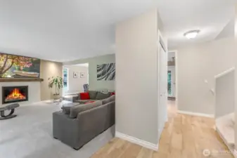 Step inside to find a bright and open living area. The foyer transitions smoothly into the main living spaces, highlighting wood-style flooring and a functional layout designed for everyday living.