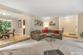 From this angle, you can appreciate the open connection between the living and dining spaces. Neutral tones, fresh flooring, and generous room dimensions offer flexibility for your personal style.