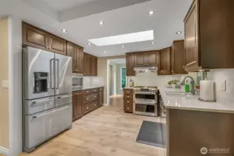 From this angle, you can see the full layout of the kitchen—expansive cabinetry for storage, premium appliances, and durable flooring that flows seamlessly throughout the main level.