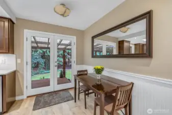 The casual dining nook is perfectly placed next to double doors that lead to the back deck. It’s a sunny, cheerful spot to enjoy meals while overlooking the lush, private backyard.