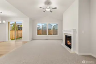 Vaulted ceilings and a cozy fireplace with tile surround & mantel. Wood wrap windows and screens are included.