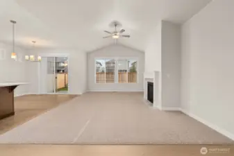 Vaulted ceilings and a cozy fireplace with tile surround & mantel. Wood wrap windows and screens are included.