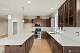 Beautiful quartz countertops and full tile backsplash. Frosted door leads to pantry.