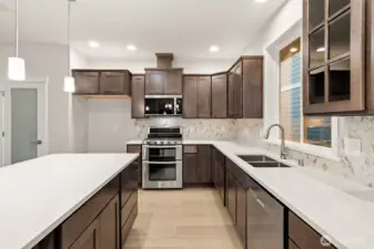Beautiful quartz countertops and full tile backsplash. Frosted door leads to pantry.