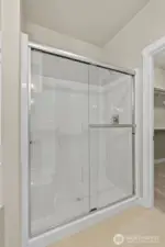 Primary bath comes standard with a separate walk-in shower with glass doors.