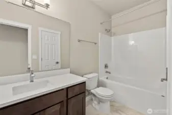 Full bath with undermount sink, quartz countertops and backsplash; tub/shower and  a linen closet!