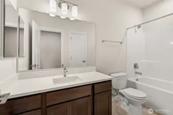 Full bath with undermount sink, quartz countertops and backsplash; tub/shower and a linen closet!