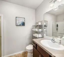3/4 Bathroom off the main level hallway. Has a shower too! Across the hall from the main level bedroom / den depending on how you choose to use it.