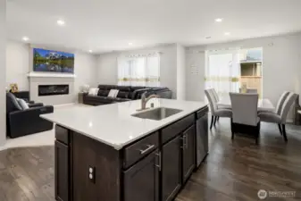 Open Design in the main living area! Larger kitchen island with sink and breakfast bar. Nice wood flooring.  Semi formal dining area, and a big living room with fireplace!