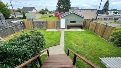 Backyard space looking at garage and alley parking