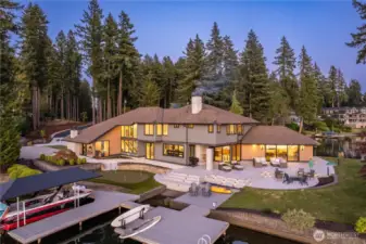Northwest side of the property. Two docks adjoined by a bridge. Extensive patios, 4 hole putting green.