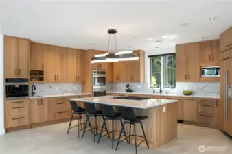 This view of the kitchen really showcases the designer chandelier and of course eveyone will clamor to do dishes when you’ve  got a front row view of the water at The Pointe at Lake Sawyer