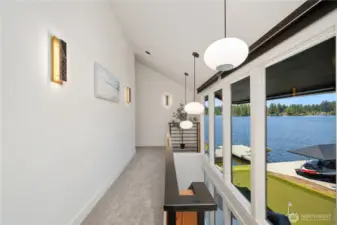 Let’s go upstairs. You can enjoy the views while walking the stairs with this full wall of windows at The Pointe at Lake Sawyer