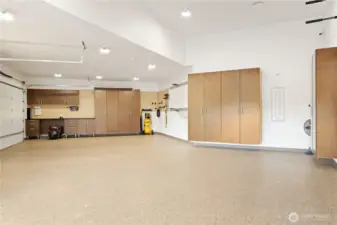 Inside the detached shop, extra high ceilings for your RV. Lots of cabinets for your stuff, squeaky clean with the epoxied floors. It can hold 3, maybe 4 cars.