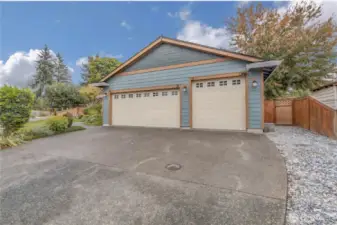 3 Car garage with large parking pad.