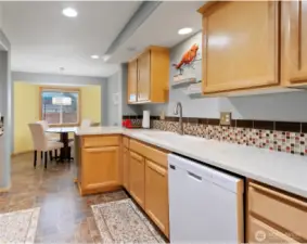 Walk through galley style kitchen with quartz counters