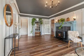 Welcoming living room with cozy wood-burning fireplace and gas stove.