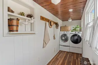 Laundry room with stylish finishes and efficient use of space, combining storage and function in a bright, organized layout.