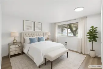 1 of 2 light filled bedrooms with modern luxury plank vinyl.