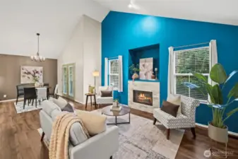 Family room has soaring ceilings, bright windows and a gas fireplace perfect for cool evenings