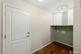 Roomy mudroom/laundry in a perfect spot between kitchen and garage