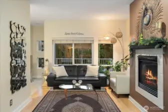 Open living with high ceiling, gas fireplace, dining, and breakfast bar. Built-in ceiling speakers throughout.