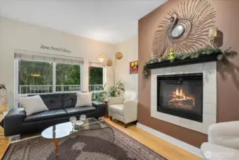 Open living with high ceiling, gas fireplace, dining, and breakfast bar. Built-in ceiling speakers throughout.