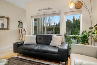 Open living with high ceiling, gas fireplace, dining, and breakfast bar. Built-in ceiling speakers throughout.