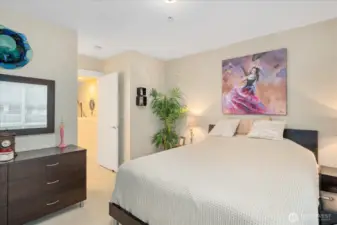 Primary bedroom fits king, dresser, and seating nook.