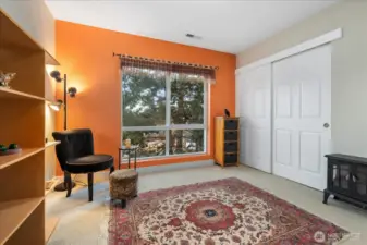 2nd bedroom with a large picture window and treetops views.