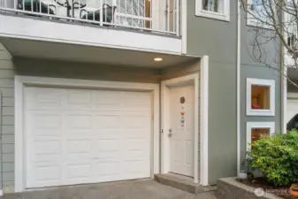 Attached garage with covered entry and driveway parking.
