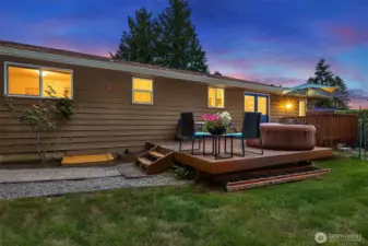 Gorgeous back deck faces the serenity of the ajacent forest