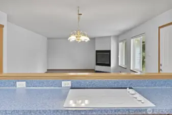 A view from the cook top into the family room. With a wood burning stove ad a doorway to the back deck.