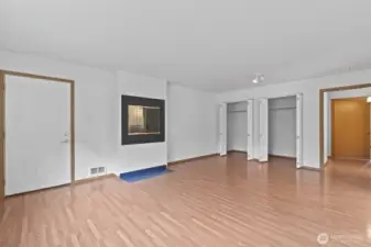 The fireplace in the primary suite is set up higher so you can easily load your wood into it. Double closet on the far wall. Door that leads to back deck.