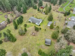 Here is a great view that shows the fenced yard off of the back of the house and the positions of the outbuildings on the property.
