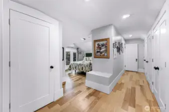 Upper level suite showing extensive wall of storage including the placement of high end washer & dryer.