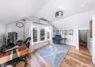 Third bedroom/office with book case shelving open to show closet entry