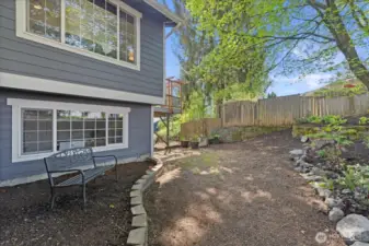 Front flower beds are filled with blooming perennials and new flowerbed along the house is ready for your favorite plants.