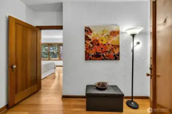From the bedroom into the main entry, bath is on the left.