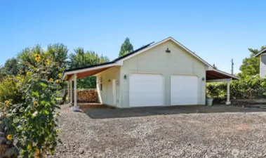 In addition to the attached garage, this detached two vehicle and shop structure  is the perfect spot for the hobbyist, artist or mechanic